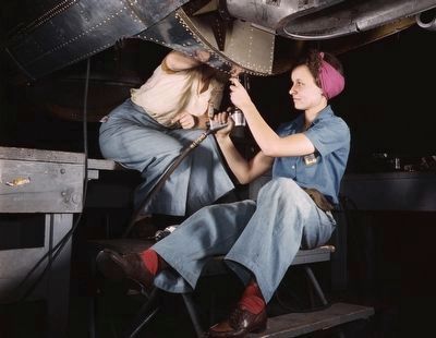 Women riveters at work on an aircraft image. Click for full size.