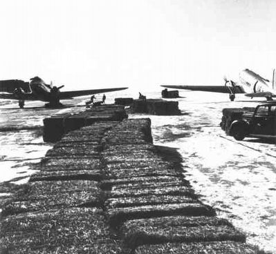 Bales were sometimes dropped on the range near stranded cattle. image. Click for full size.