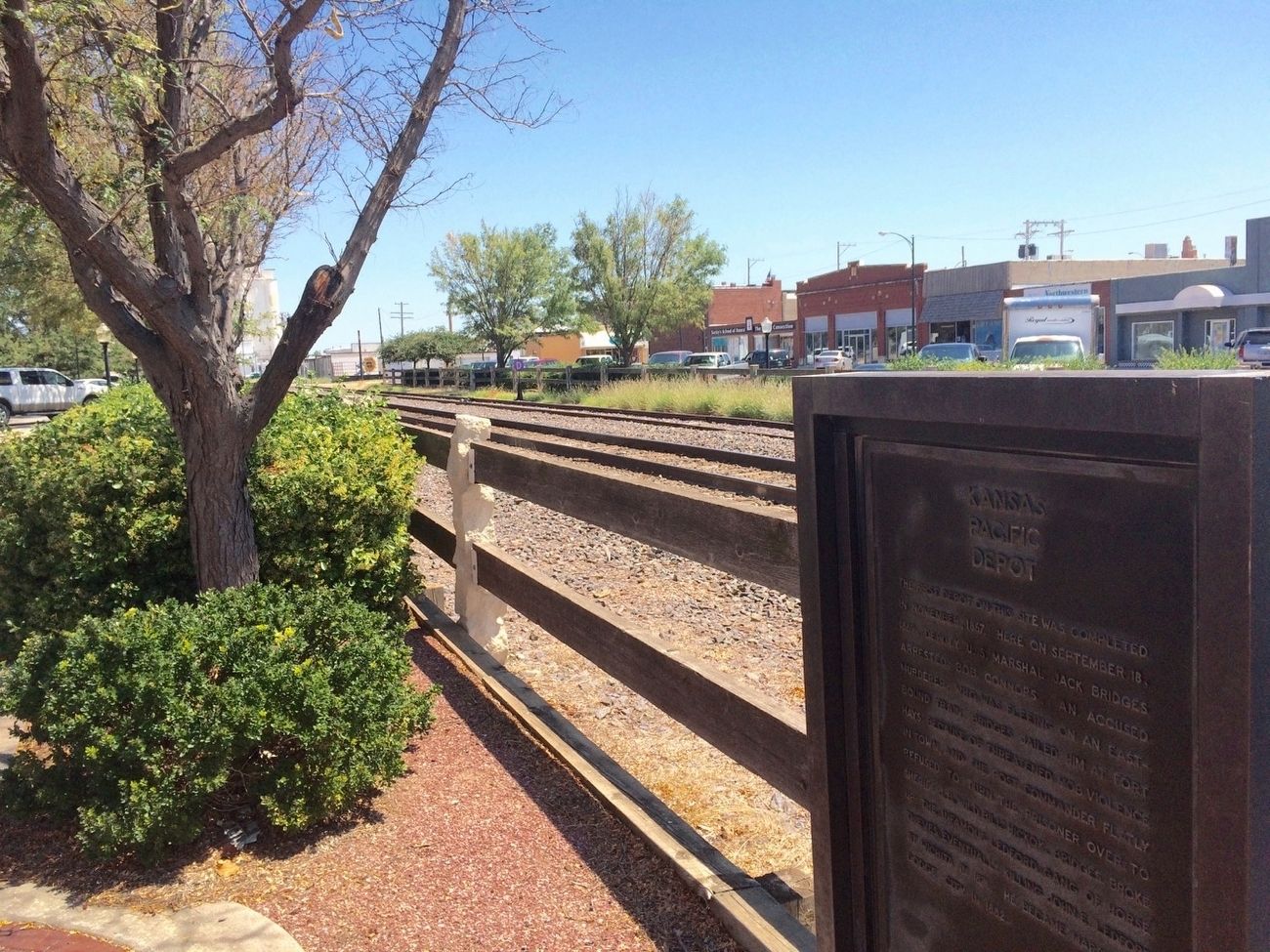 Kansas Pacific Depot Marker in front of train tracks in Union Pacific Plaza. image. Click for full size.