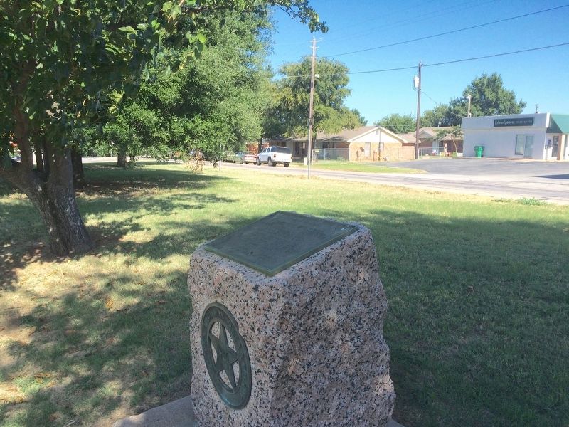 1936 Pink Granite Centennial marker with US Highway 82 in background. image. Click for full size.