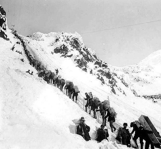 Klondikers carrying supplies ascending the Chilkoot Pass