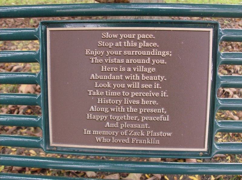Plaque on park bench next to marker image. Click for full size.