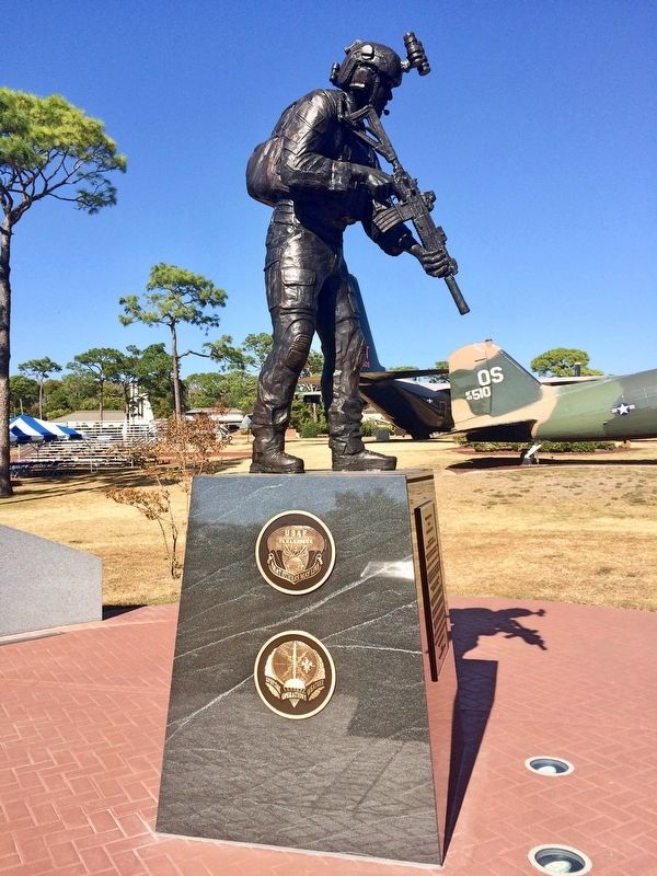 Memorial showing the USAF Pararescue & Special Operations Weather emblems. image. Click for full size.