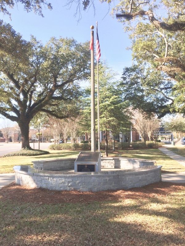Bay Minette Korean War Memorial with public library in background. image. Click for full size.