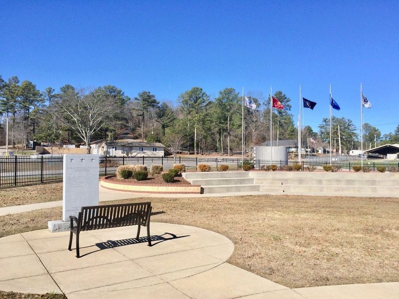 View of memorial towards Sportsman Lake Road and military service flags.. Click for full size. View of memorial towards Sportsman Lake Road and military service flags. image. Click for full size.