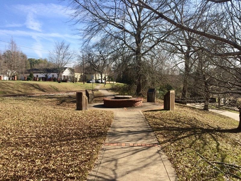 View looking south towards plaque on back left. image. Click for full size.