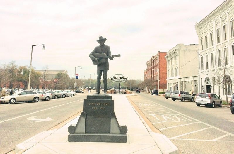 Marker, behind statue, apparently removed due to renovations of island. image. Click for full size.