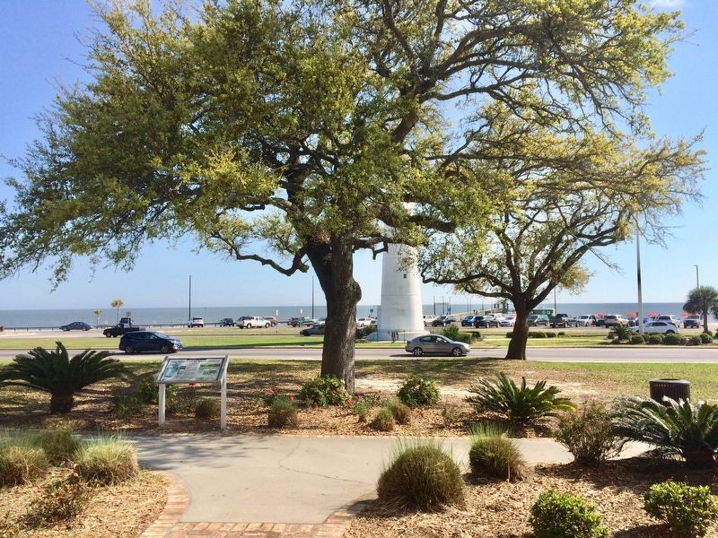 View of marker and Biloxi Lighthouse with Gulf of Mexico in background. image. Click for full size.