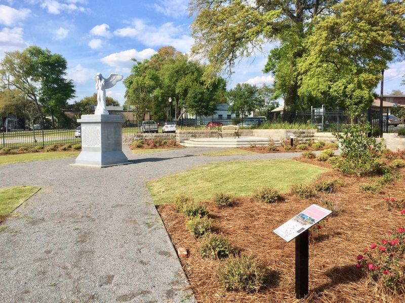 View of former cemetery and French Colonial memorial statue. image. Click for full size.