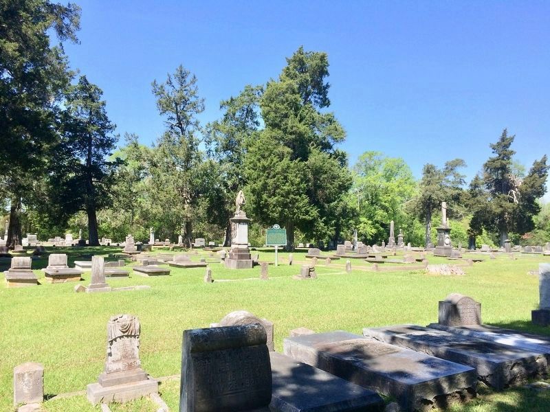 Wide view of marker and graves in the cemetery. image. Click for full size.