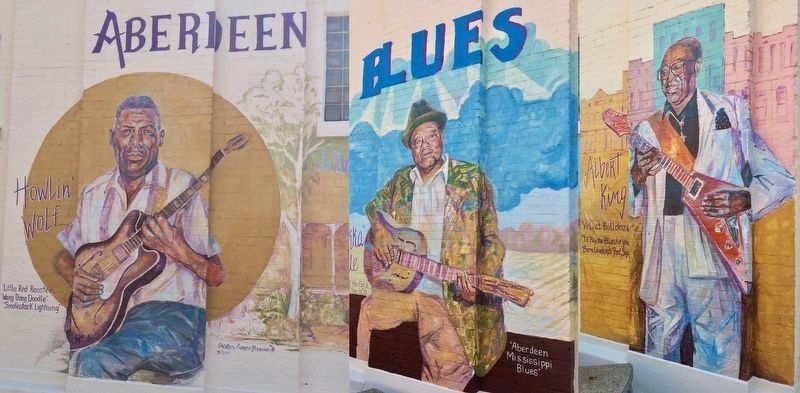Murals painted behind the marker.. Click for full size. Murals painted behind the marker. image. Click for full size.