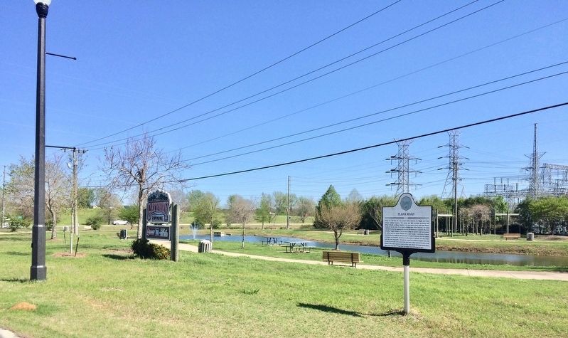 Wet areas, part of Gateway Park, along Main Street and marker. image. Click for full size.