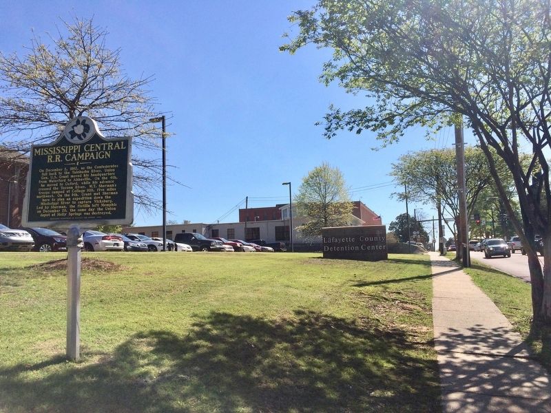 View of marker looking east on Jackson Avenue towards Courthouse Square. image. Click for full size.