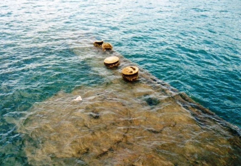 Sunken USS Arizona with oil still flowing from the ship image. Click for full size.