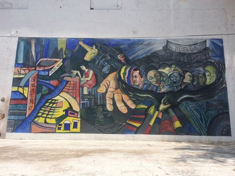 A nearby mural with a workers' rights theme image. Click for full size.