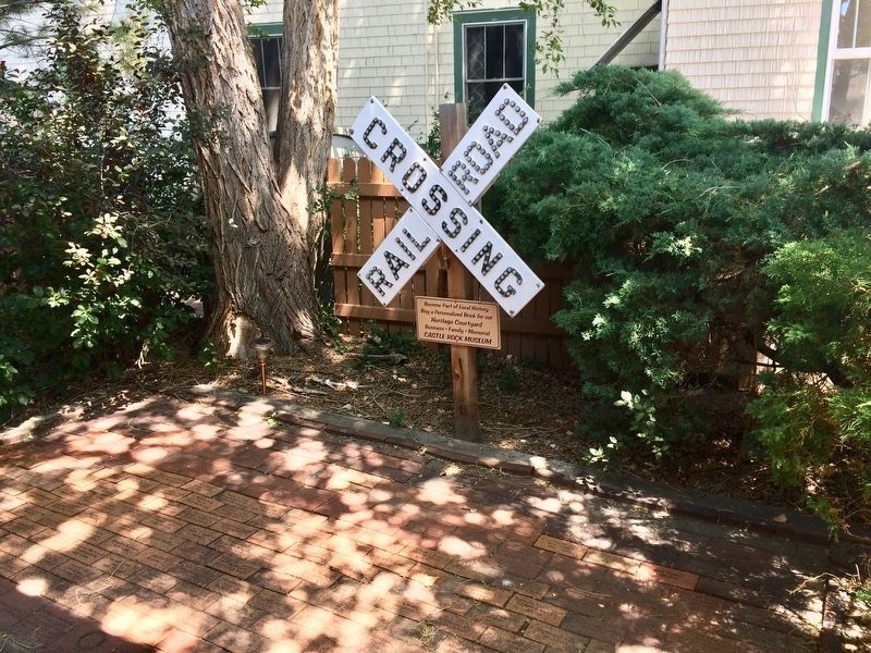 Railway Crossing sign located on side yard of former depot. image. Click for full size.