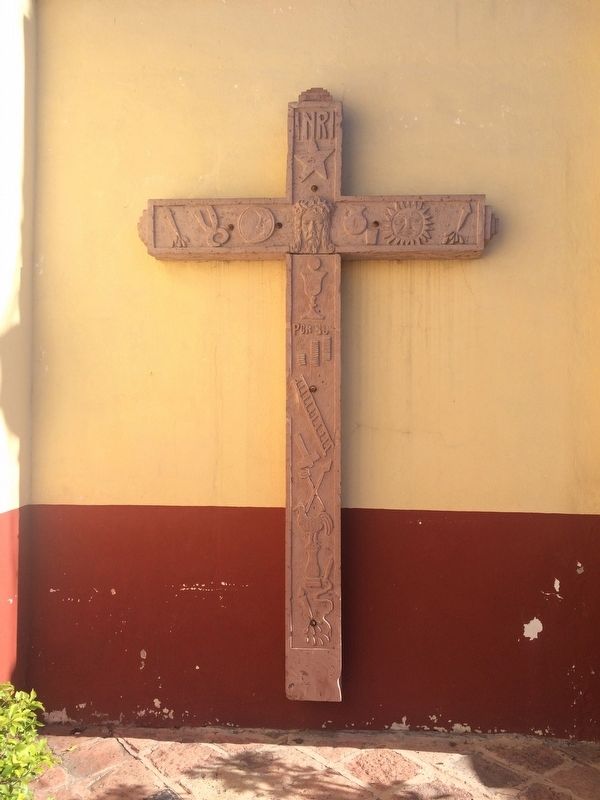An 'arma christi' made of local stone outside of the temple image. Click for full size.