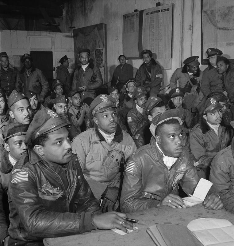 <i>Photograph of several Tuskegee airmen attending a briefing in Ramitelli, Italy, March 1945</i> image. Click for full size.
