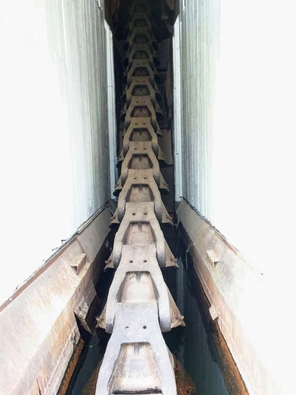 The Chain of 1 Ton Buckets Heading up into the Second Story of the Dredge. Click for full size. The Chain of 1 Ton Buckets Heading up into the Second Story of the Dredge image. Click for full size.