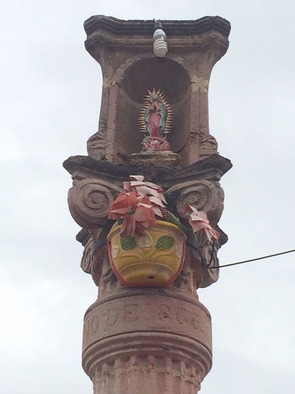 "La Pursima", the small sculpture of the Virgin of Guadalupe that tops the column. image. Click for full size.