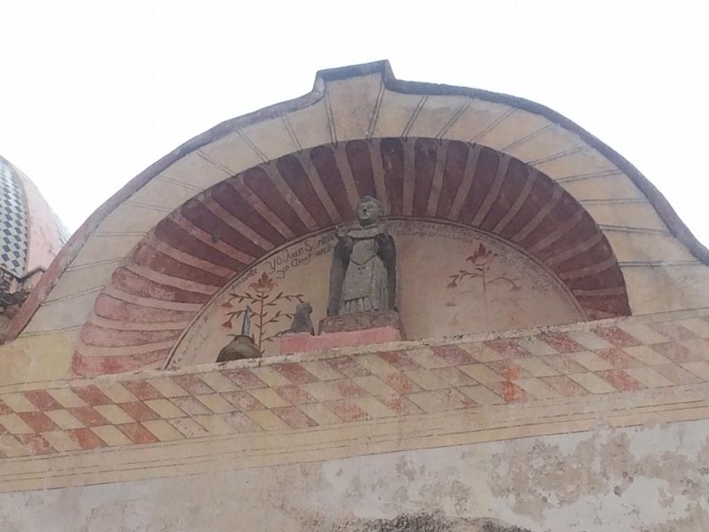The sculpture of Santo Domingo in a small niche above the entrance to the original mission. image. Click for full size.