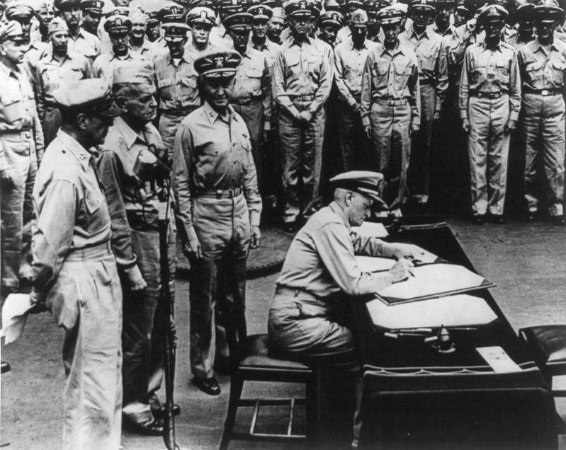 Fleet Adm. Chester W. Nimitz signing surrender document on board the USS Missouri, Sept. 3, 1945 image. Click for full size.