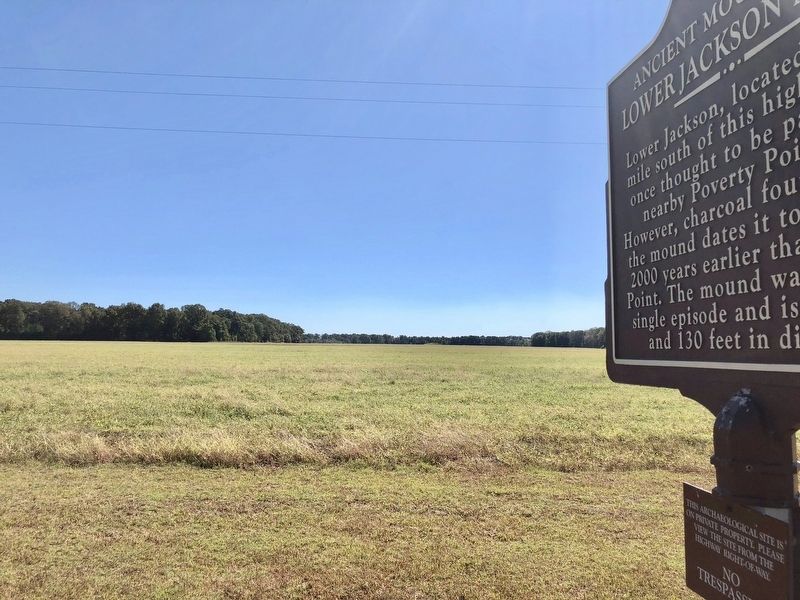 Marker with mound in distance. image. Click for full size.