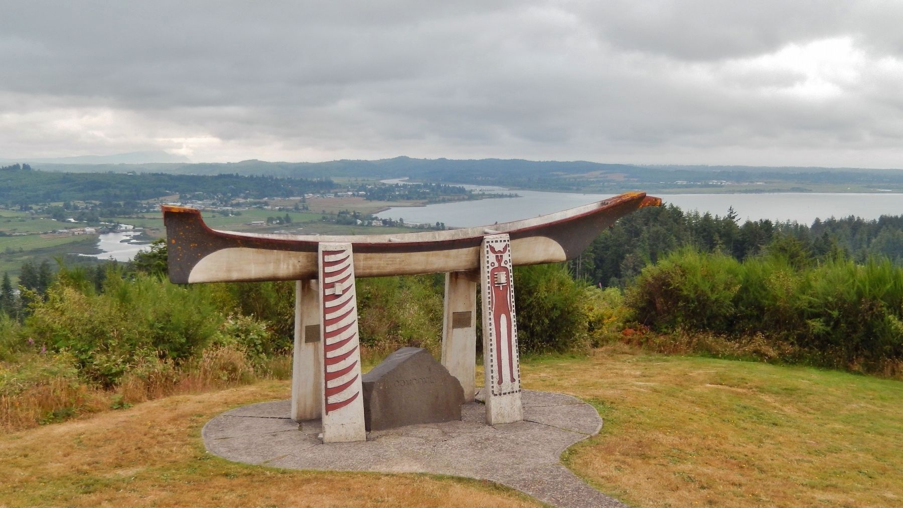 Comcomly / Burial Canoe Marker (<i>wide view; marker panels on pedestals under burial canoe</i>) image. Click for full size.