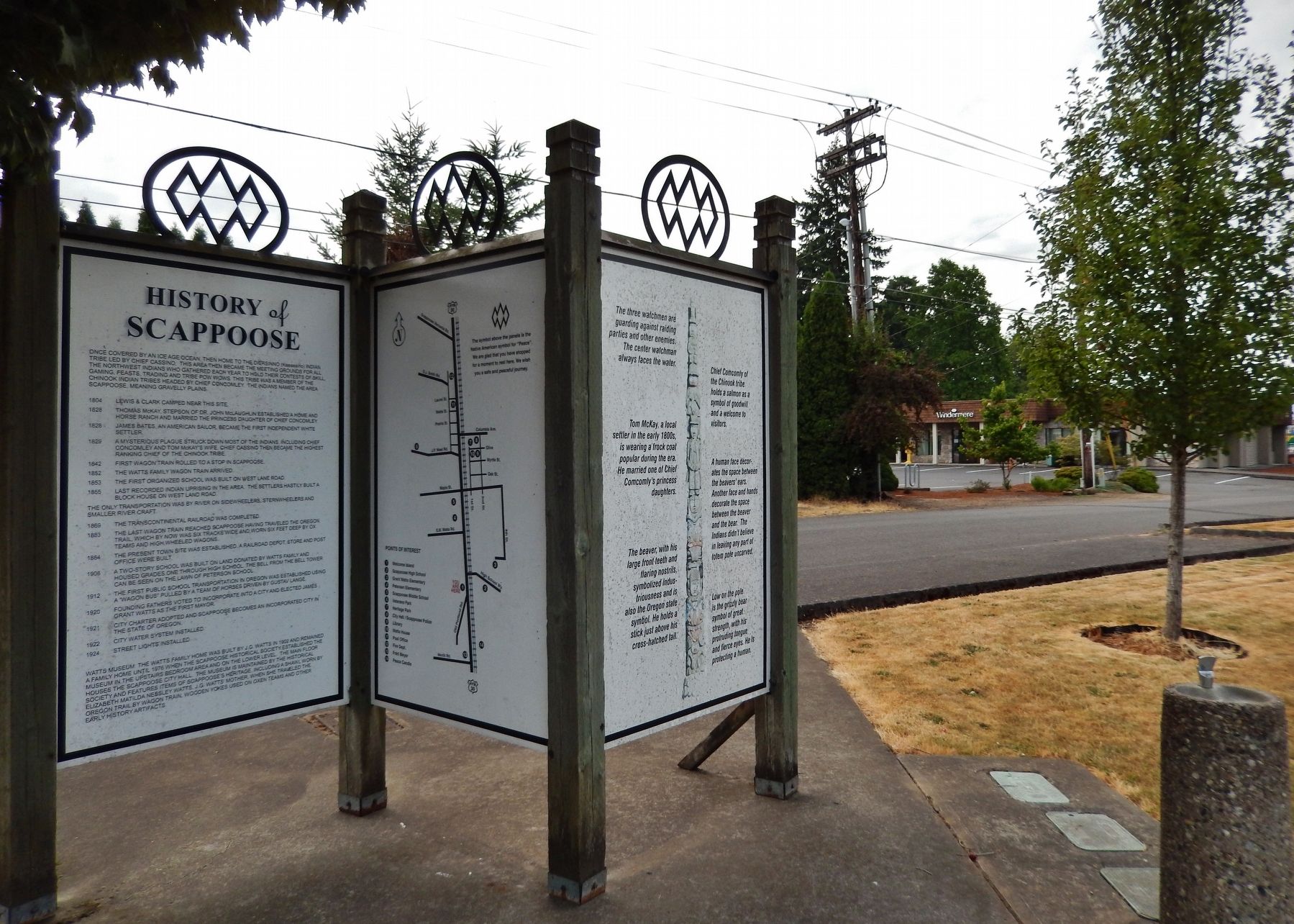 History of Scappoose Marker (<i>wide view; showing Indian peace symbol on top of panels</i>). Click for full size. History of Scappoose Marker (<i>wide view; showing Indian peace symbol on top of panels</i>) image. Click for full size.