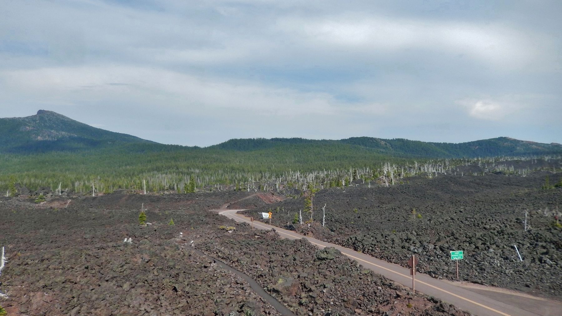 View east of Dee Wright Observatory: Black Crater, Old Wagon Road crossing, and McKenzie Pass Summit. Click for full size. View east of Dee Wright Observatory: Black Crater, Old Wagon Road crossing, and McKenzie Pass Summit image. Click for full size.