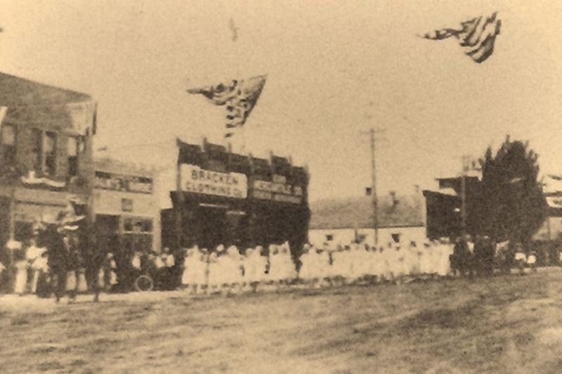 Marker detail: July 4th Parade marching past Acorn Mercantile, 1912 image. Click for full size.