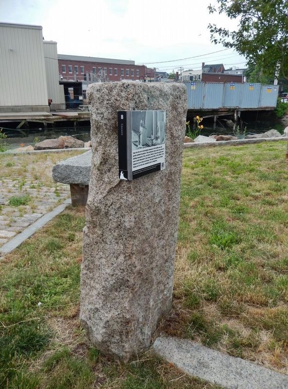 Cape Ann Granite Marker (<i>tall view; wharf in background</i>) image. Click for full size.