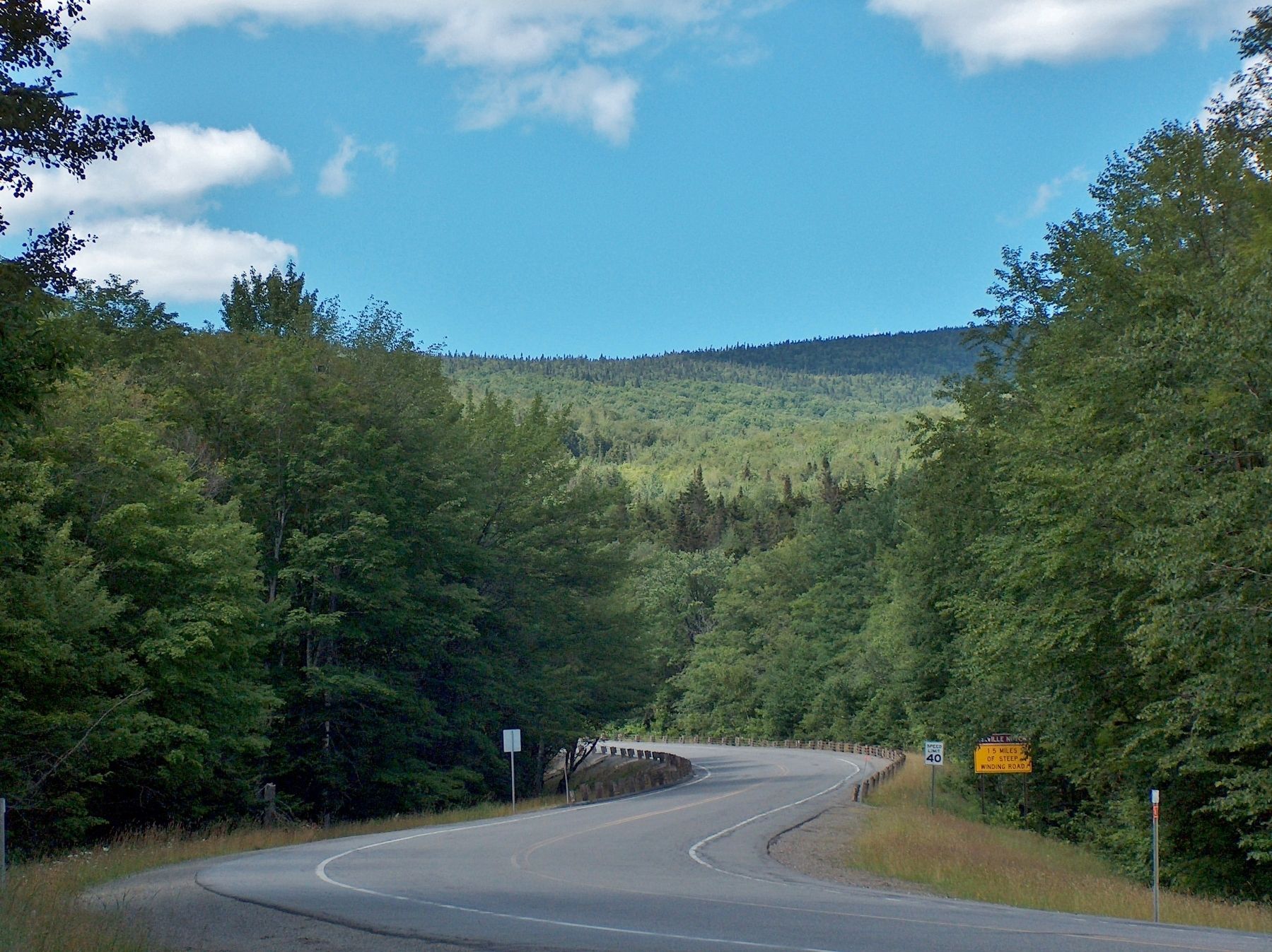 View west along Hwy 26 from State Wayside toward Dixville Notch. Click for full size. View west along Hwy 26 from State Wayside toward Dixville Notch image. Click for full size.