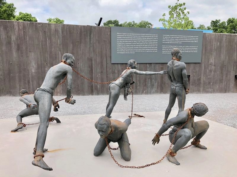 African slaves in chains statue next to marker. image. Click for full size.