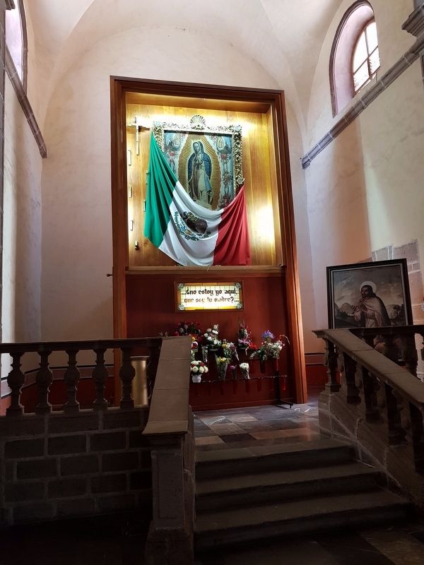A side chapel at the cathedral dedicated to the Virgin of Guadalupe with a Mexican flag image. Click for full size.