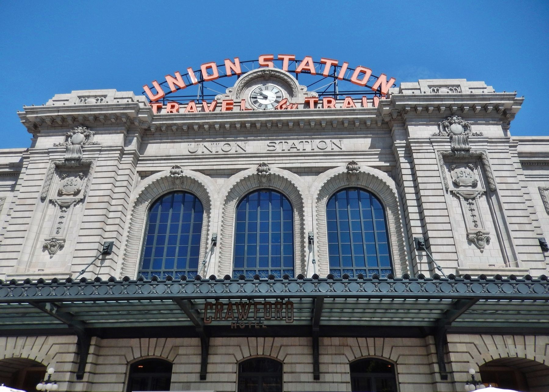 Iconic “Union Station Travel by Train” red neon sign (<i>installed 1953</i>) image. Click for full size.