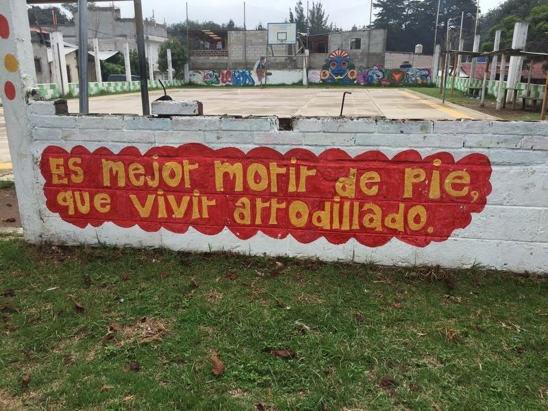 A slogan painted nearby the memorial and a basketball court image. Click for full size.