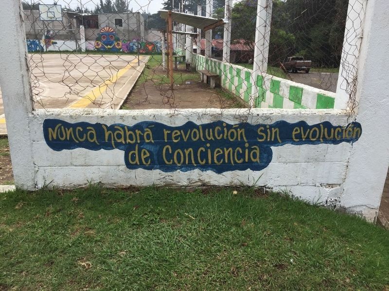 An additional painted slogan nearby the memorial and basketball court image. Click for full size.