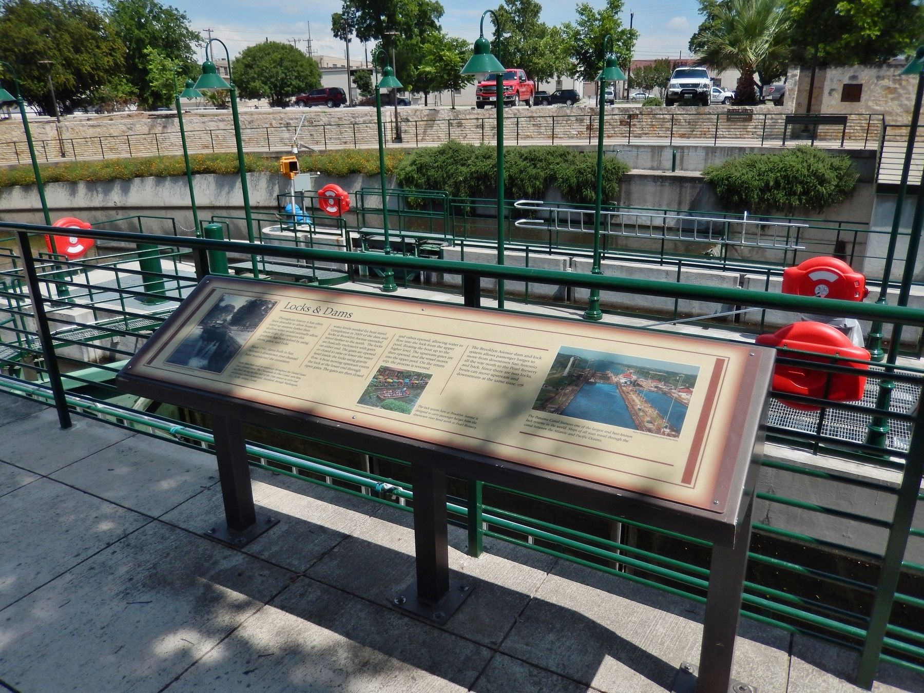 Locks & Dams Marker (<i>wide view; locks, San Antonio River and Ave B Parking lot in background</i>). Click for full size. Locks & Dams Marker (<i>wide view; locks, San Antonio River and Ave B Parking lot in background</i>) image. Click for full size.