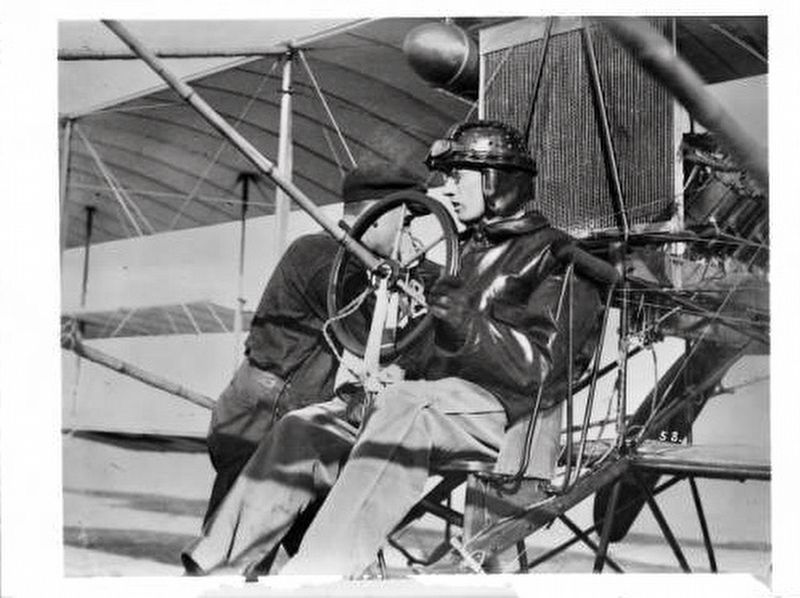<i>Pilot Glenn Martin at the controls of his aircraft as a mechanic prepares the plane...</i> image. Click for full size.