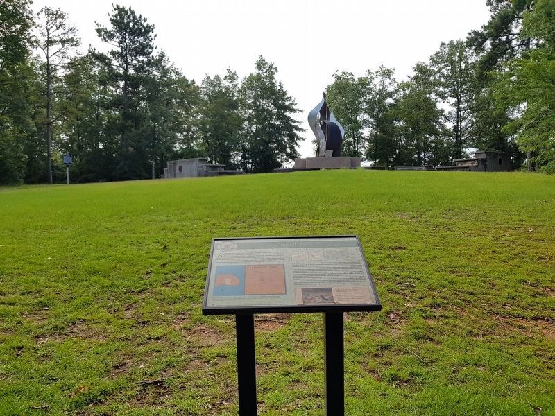 Creek Towns Marker with the Sacred Fire sculpture in the distance to the southeast. Click for full size. Creek Towns Marker with the Sacred Fire sculpture in the distance to the southeast image. Click for full size.