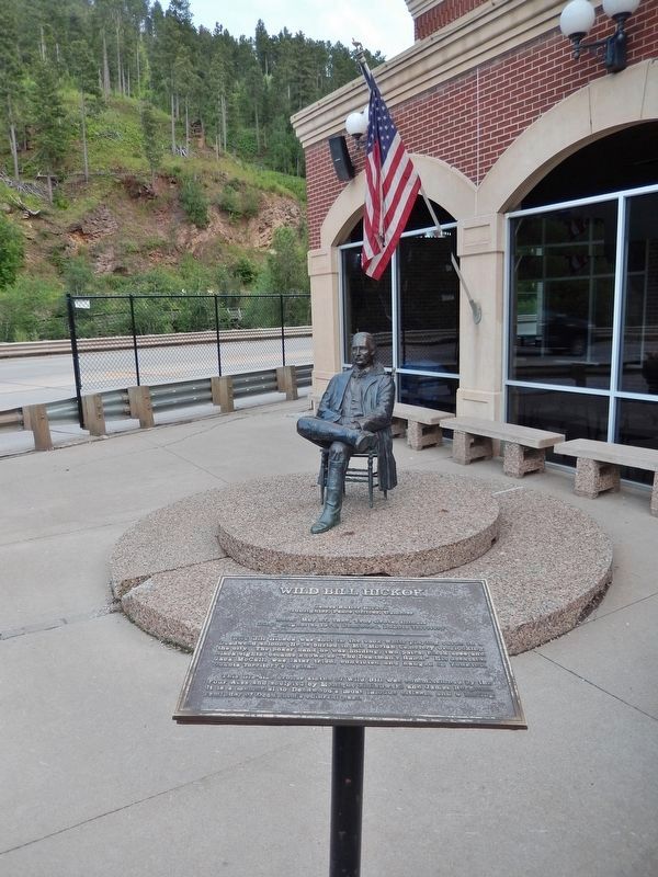 Wild Bill Hickok Marker (<i>tall view; statue & US Highway 85 in background</i>). Click for full size. Wild Bill Hickok Marker (<i>tall view; statue & US Highway 85 in background</i>) image. Click for full size.