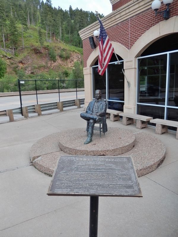 Wild Bill Hickok Marker (<i>tall view; statue & US Highway 85 in background</i>) image. Click for full size.