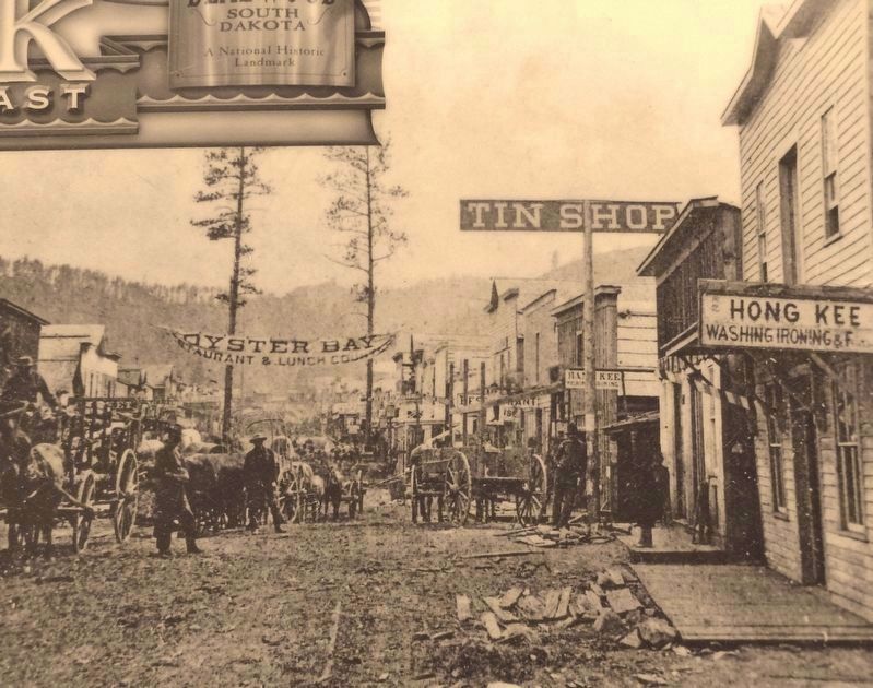 Marker detail: 1876 Deadwood photo shows some of the Chinese businesses on Main Street. Click for full size. Marker detail: 1876 Deadwood photo shows some of the Chinese businesses on Main Street image. Click for full size.