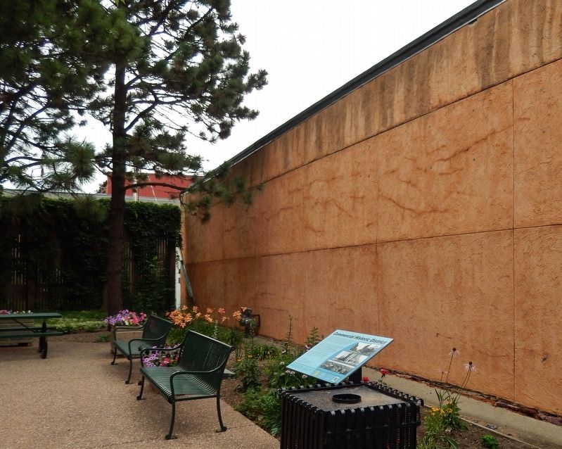 Commercial Historic District Marker (<i>wide view; marker beside bench, within small plaza</i>) image. Click for full size.