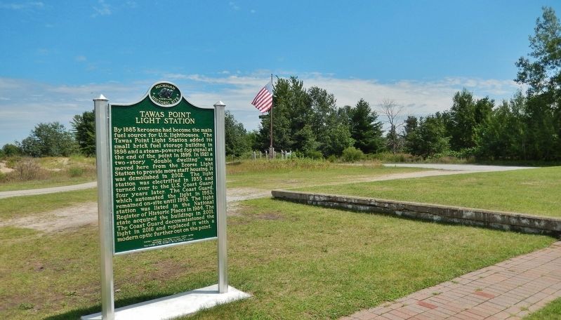 Tawas Point Light Station Marker (<i>side 2; wide view looking west; parking lot in background</i>) image. Click for full size.