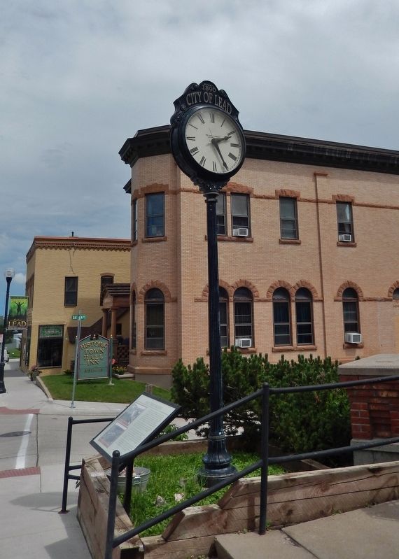 Halloran Block Marker (<i>tall view; looking east along Main Street; marker is beside clock</i>) image. Click for full size.