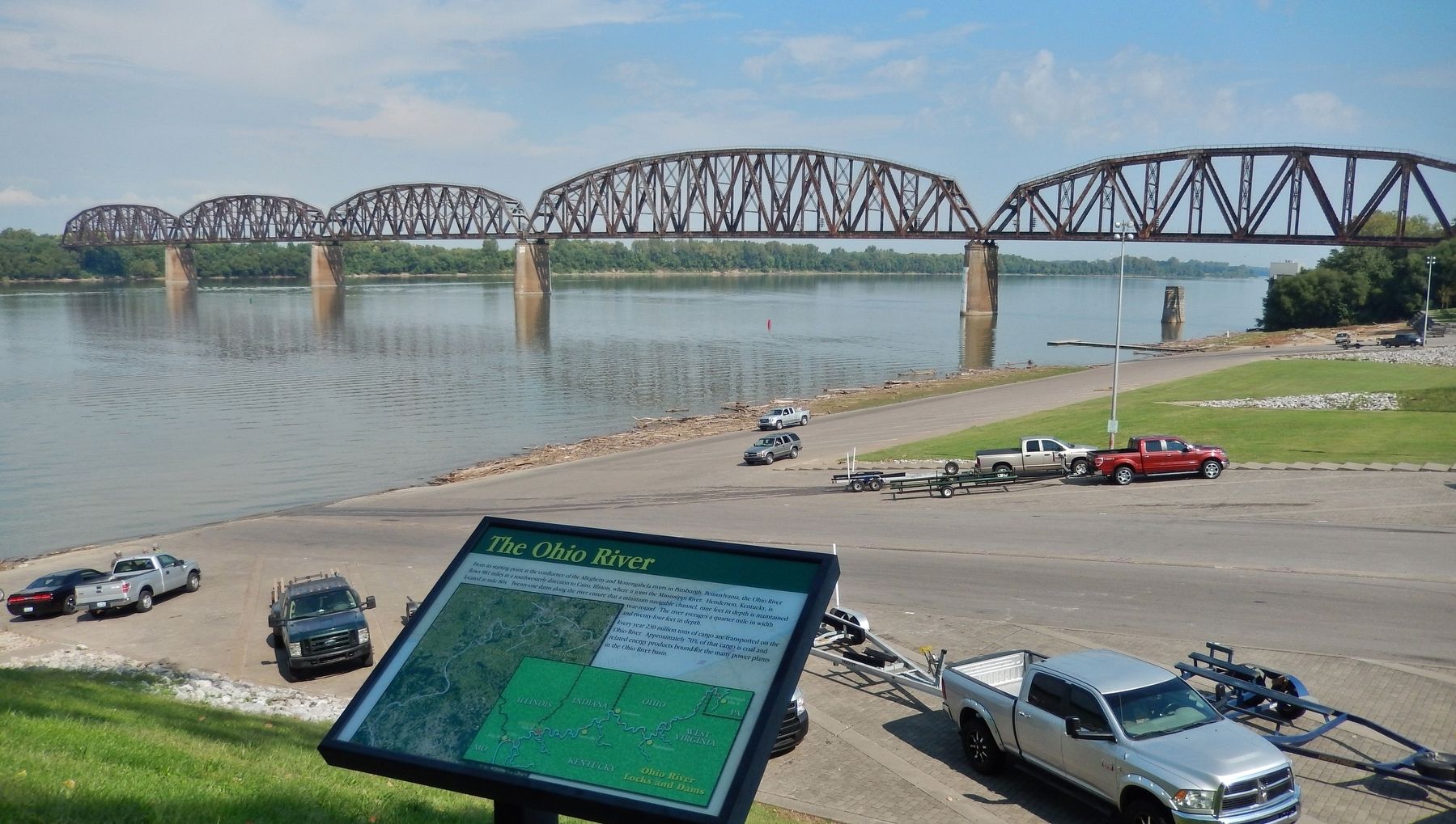 The Ohio River Marker (<i>wide view; boat ramp, Ohio River, and railroad bridge in background</i>) image. Click for full size.