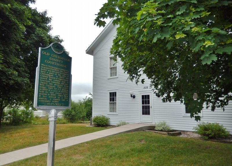 Old Cheboygan County Courthouse Marker (<i>wide view; courthouse in background</i>) image. Click for full size.