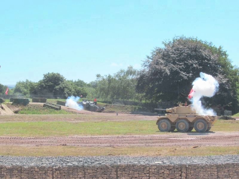 Staff members demonstrate a tank battle in the Kuwait Arena image. Click for full size.